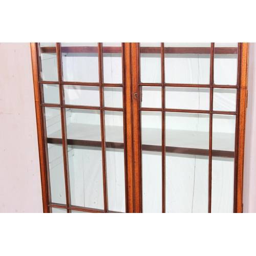 4 - An antique glazed mahogany bookcase with cupboard base