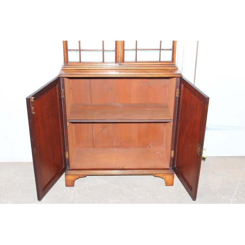 4 - An antique glazed mahogany bookcase with cupboard base