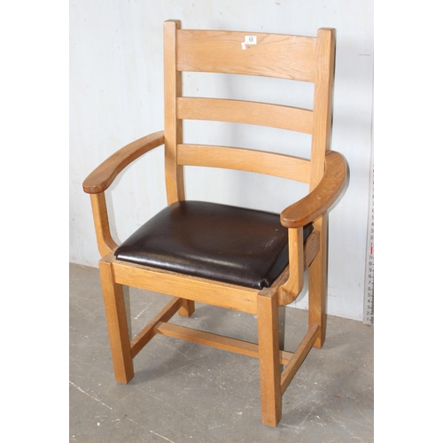 68 - A large light oak open seated armchair