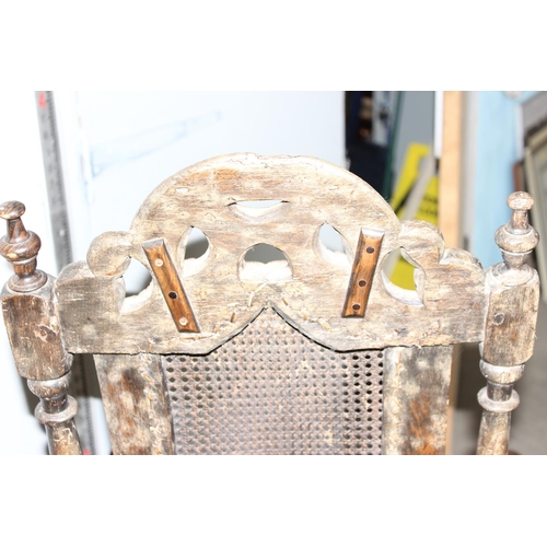 7 - A mid - late 17th century Carolean carved walnut chair, with caned seat and back