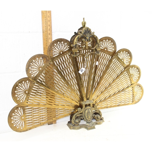 83 - An early 20th century folding brass peacock fire screen