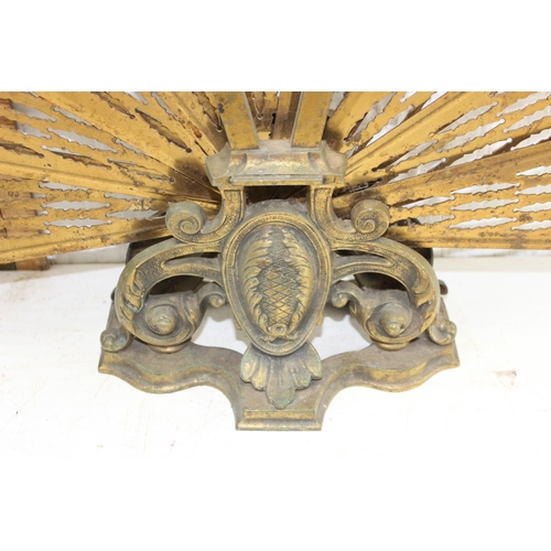 83 - An early 20th century folding brass peacock fire screen