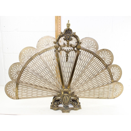 83 - An early 20th century folding brass peacock fire screen