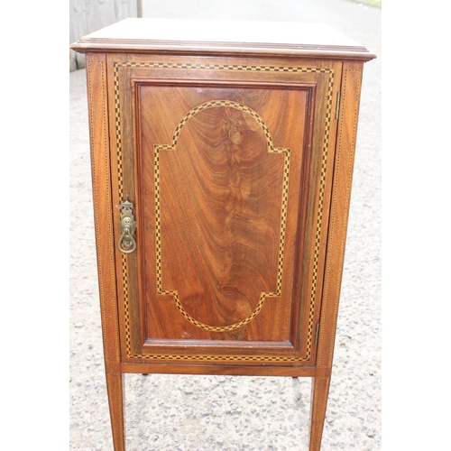 86 - An Edwardian Sheraton style cupboard on legs