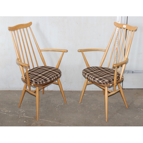 4 - A pair of blonde Ercol Goldsmith pattern carver chairs with cushions