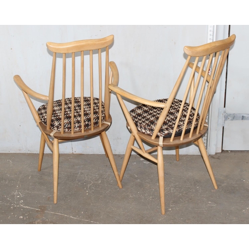 4 - A pair of blonde Ercol Goldsmith pattern carver chairs with cushions