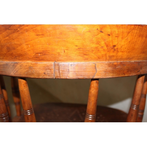 24 - An antique tub shaped wooden armchair with pierced wooden seat, stamped marks to back rail