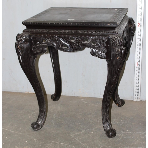 56 - Chinese ebonised wooden side table with highly carved details