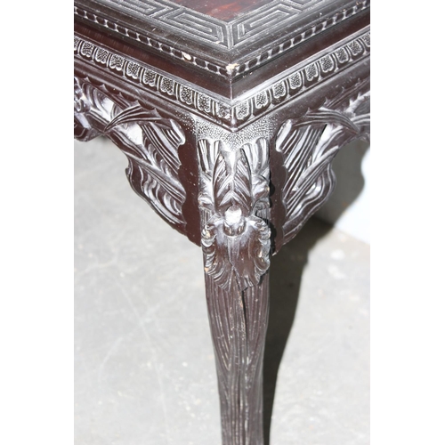 56 - Chinese ebonised wooden side table with highly carved details