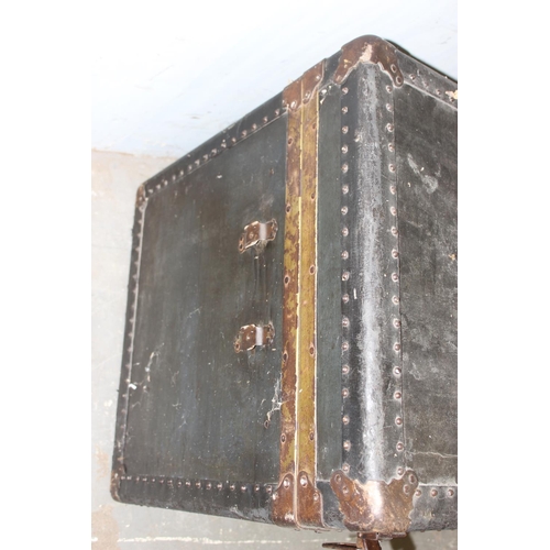 76 - A large vintage black painted shipping trunk