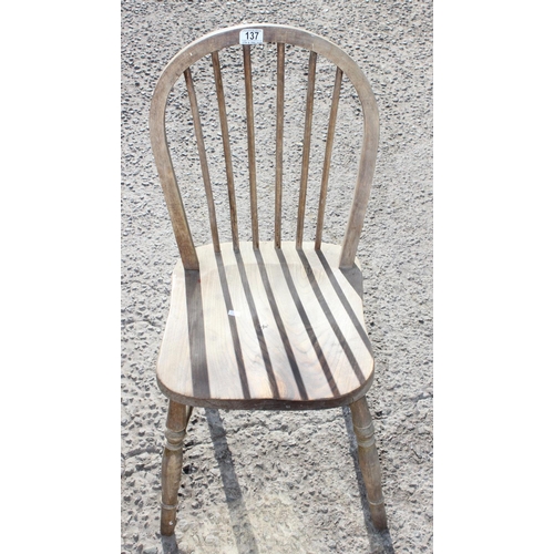 137 - A pair of oak spindle back kitchen chairs