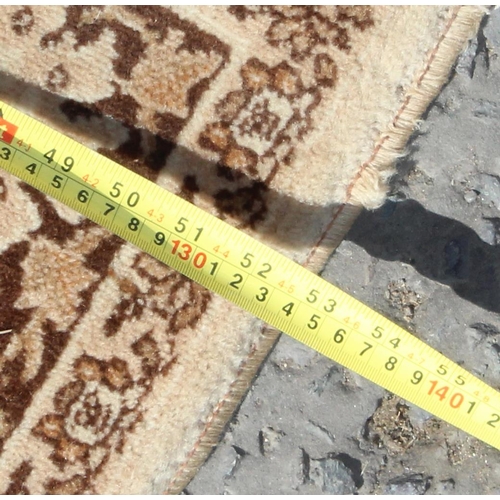 209 - Decorative cream ground rug, approx 205cm x 135cm