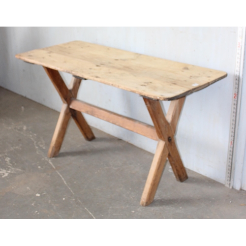 12 - A vintage rustic pine X frame table, approx 135cm x 59cm