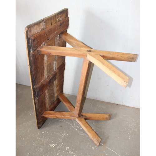 12 - A vintage rustic pine X frame table, approx 135cm x 59cm