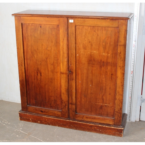 19 - A large antique stained wooden cupboard with interior shelves, approx 121cm wide