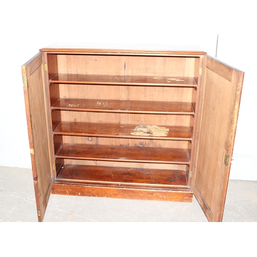19 - A large antique stained wooden cupboard with interior shelves, approx 121cm wide