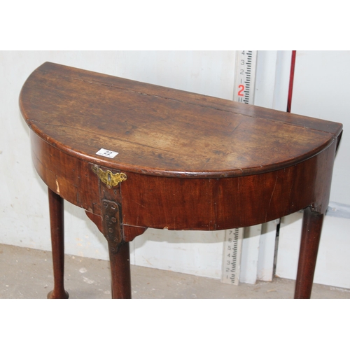 22 - An unusual Georgian mahogany demi-lune drop leaf tea or console table with locking compartment, stan... 
