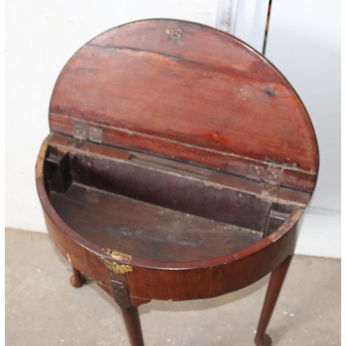 22 - An unusual Georgian mahogany demi-lune drop leaf tea or console table with locking compartment, stan... 