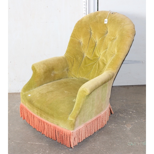 25 - A Victorian button backed low armchair with green corduroy upholstery