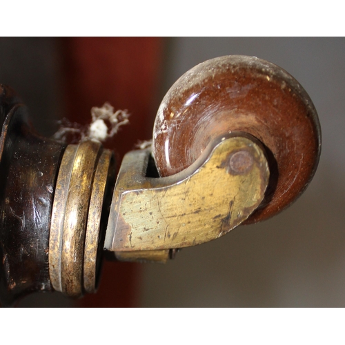 27 - An antique deep seated 2 seater sofa standing on turned wooden legs with brass and ceramic castors, ... 