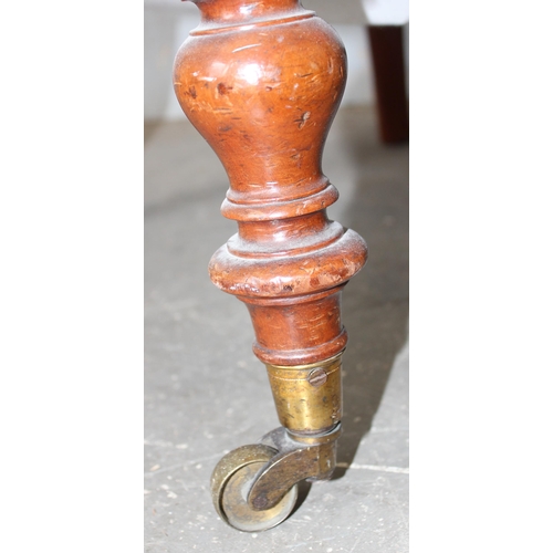 29 - An antique low chair with later floral upholstery, brass and ceramic castors stamped Cope Collinson ... 