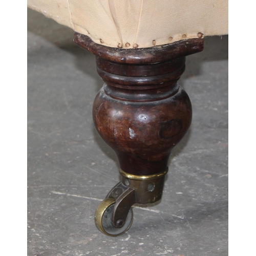 30 - A 19th century button backed armchair with brass and ceramic castors stamped Charlton's Patent