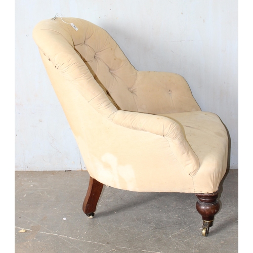 30 - A 19th century button backed armchair with brass and ceramic castors stamped Charlton's Patent