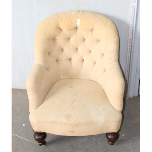 30 - A 19th century button backed armchair with brass and ceramic castors stamped Charlton's Patent