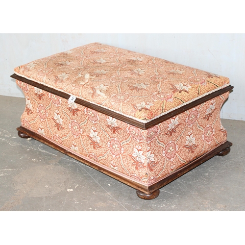 32 - An antique mahogany sarcophagus shaped ottoman with later upholstery and patent ceramic castors