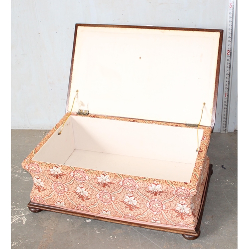 32 - An antique mahogany sarcophagus shaped ottoman with later upholstery and patent ceramic castors