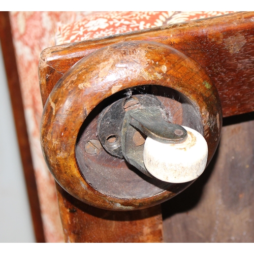 32 - An antique mahogany sarcophagus shaped ottoman with later upholstery and patent ceramic castors