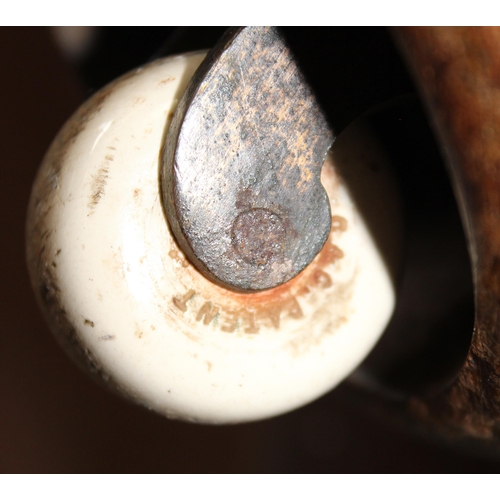32 - An antique mahogany sarcophagus shaped ottoman with later upholstery and patent ceramic castors
