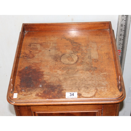 34 - An antique mahogany bedside cabinet
