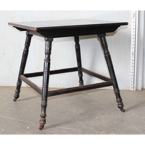 36 - A Victorian ebonised table in the manner of Liberty & Co with splayed legs, stamped number to base