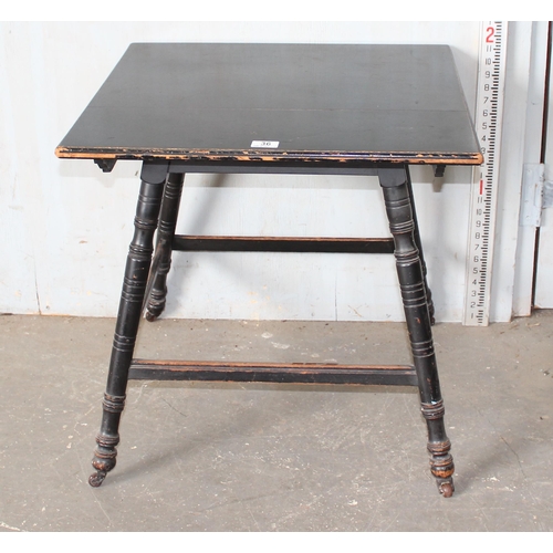 36 - A Victorian ebonised table in the manner of Liberty & Co with splayed legs, stamped number to base