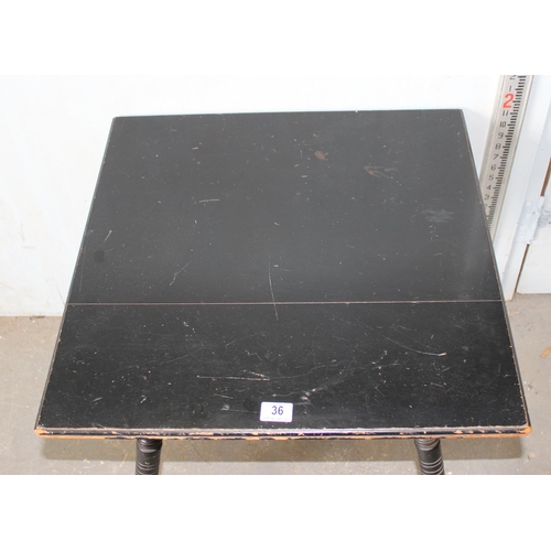 36 - A Victorian ebonised table in the manner of Liberty & Co with splayed legs, stamped number to base