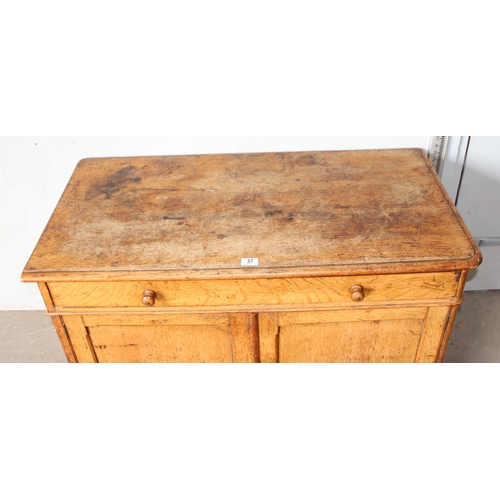 37 - A small vintage oak cupboard with one long drawer, approx 107cm wide