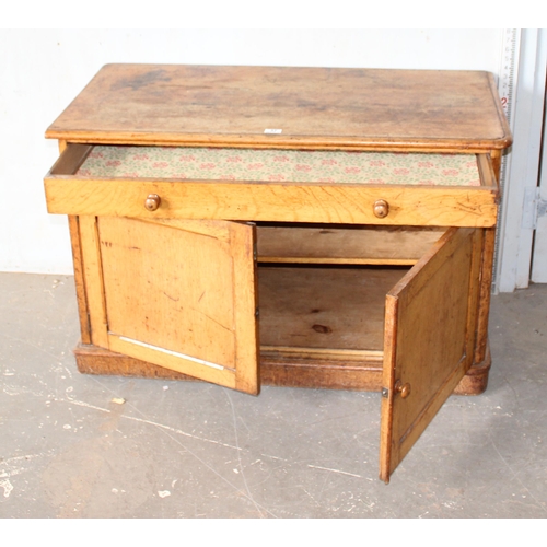 37 - A small vintage oak cupboard with one long drawer, approx 107cm wide