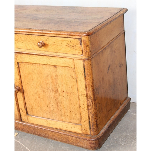 37 - A small vintage oak cupboard with one long drawer, approx 107cm wide