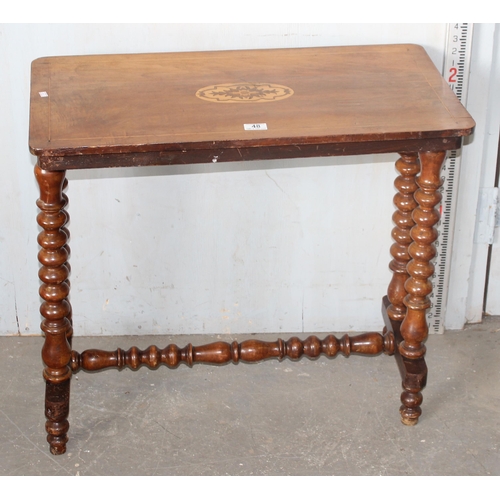 48 - An antique marquetry inlaid table standing on bobbin turned supports
