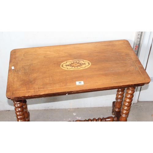 48 - An antique marquetry inlaid table standing on bobbin turned supports