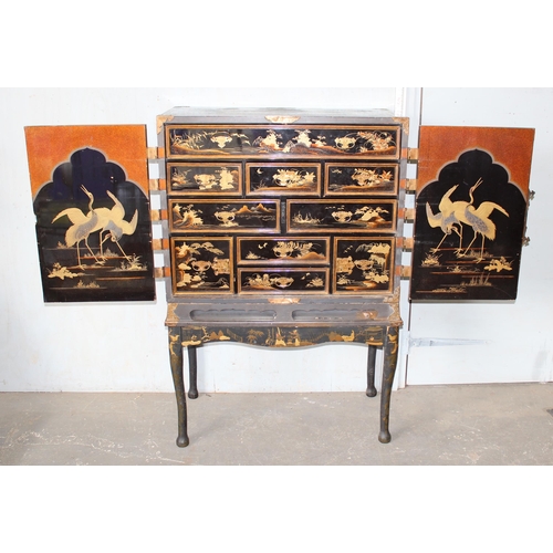 8 - An antique Japanese lacquered cabinet on stand with brass fittings and original key, likely c.1800 o... 