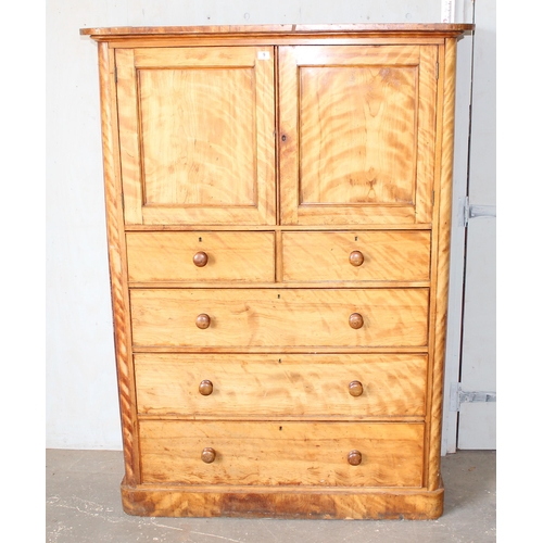 9 - An antique satinwood linen press type cupboard standing on over 2/3 drawers