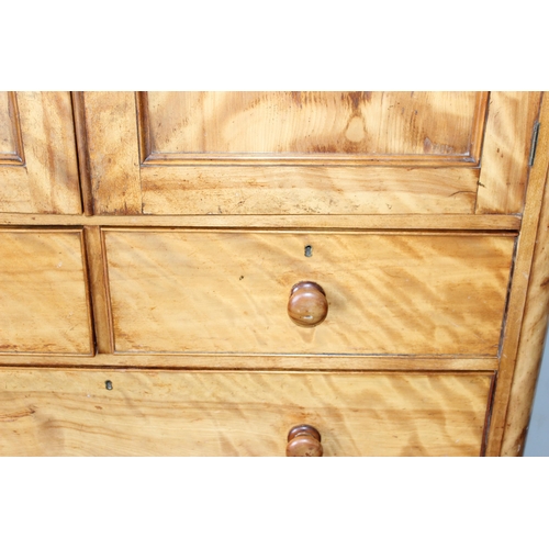 9 - An antique satinwood linen press type cupboard standing on over 2/3 drawers