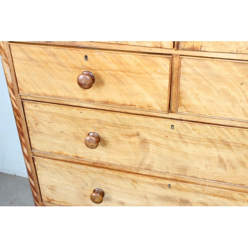 9 - An antique satinwood linen press type cupboard standing on over 2/3 drawers