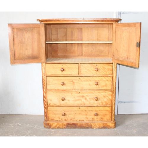 9 - An antique satinwood linen press type cupboard standing on over 2/3 drawers