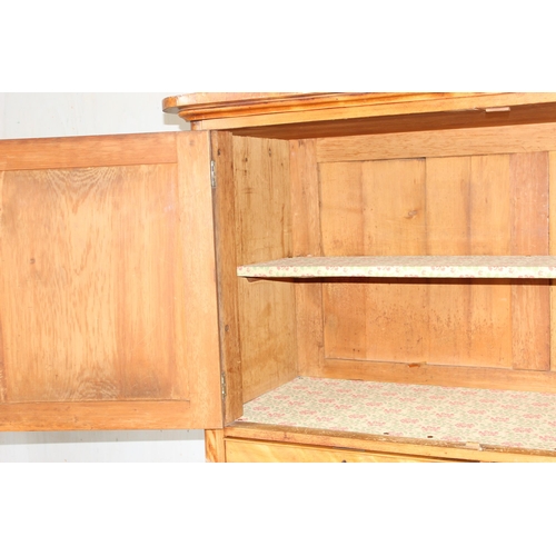 9 - An antique satinwood linen press type cupboard standing on over 2/3 drawers