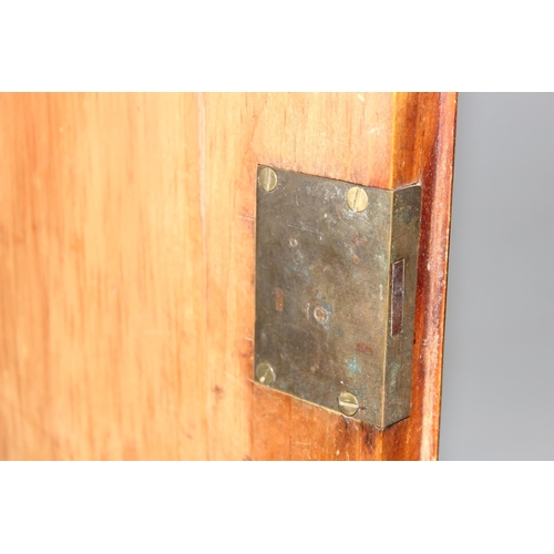 9 - An antique satinwood linen press type cupboard standing on over 2/3 drawers