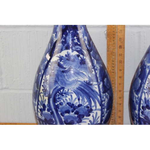 1628A - A large pair of Japanese blue and white porcelain floor vases of bottle form with frilled rim, likel... 