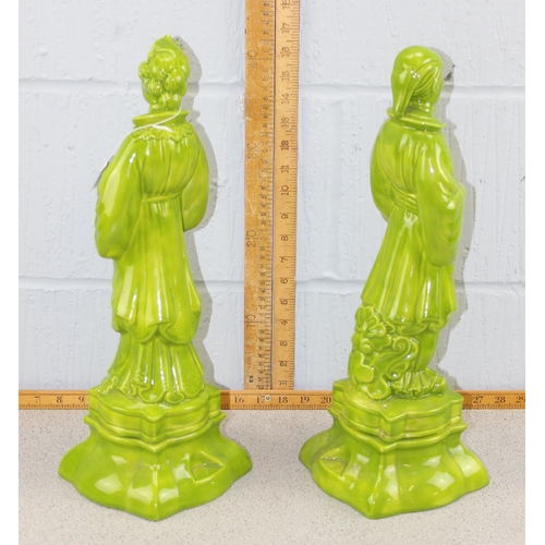 1825A - A pair of large green glazed pottery figures signed M. Davis 1970